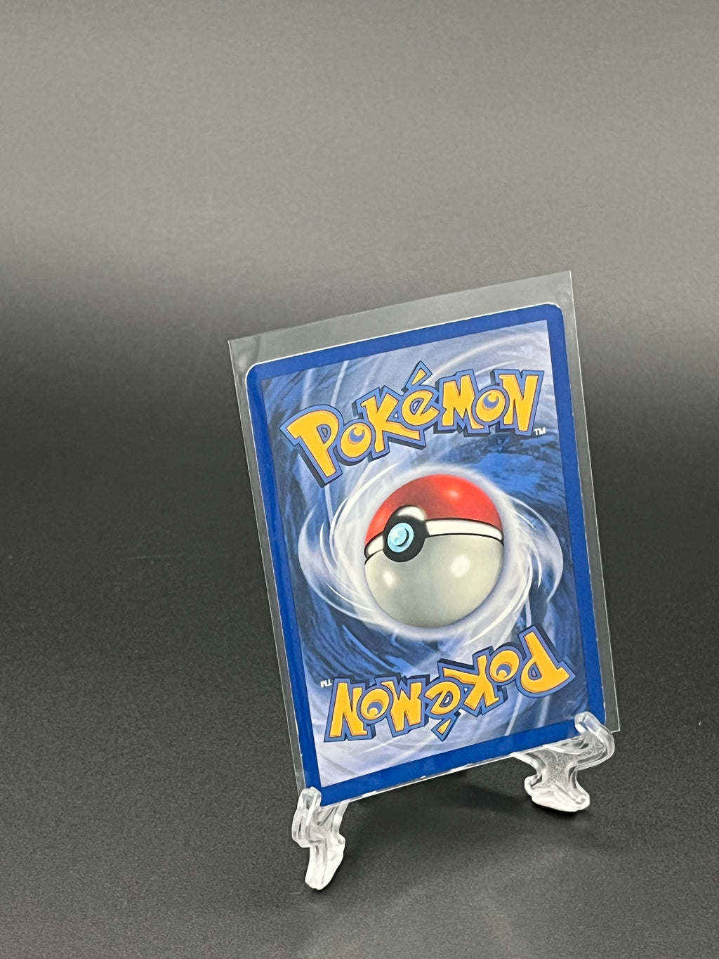 Pokémon trading card in clear packaging on a dark background
