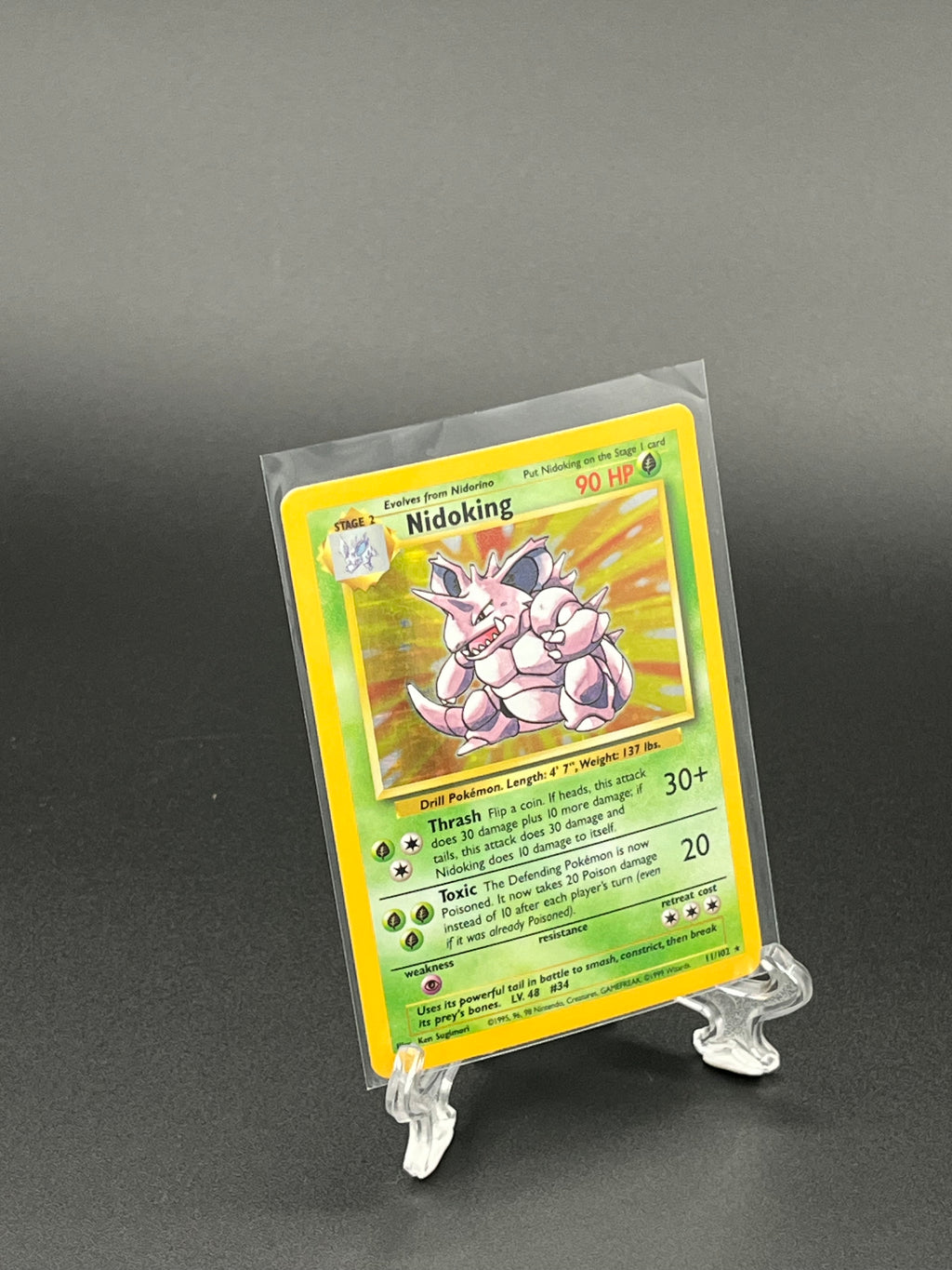 Pokémon trading card in a clear protective sleeve on a dark background