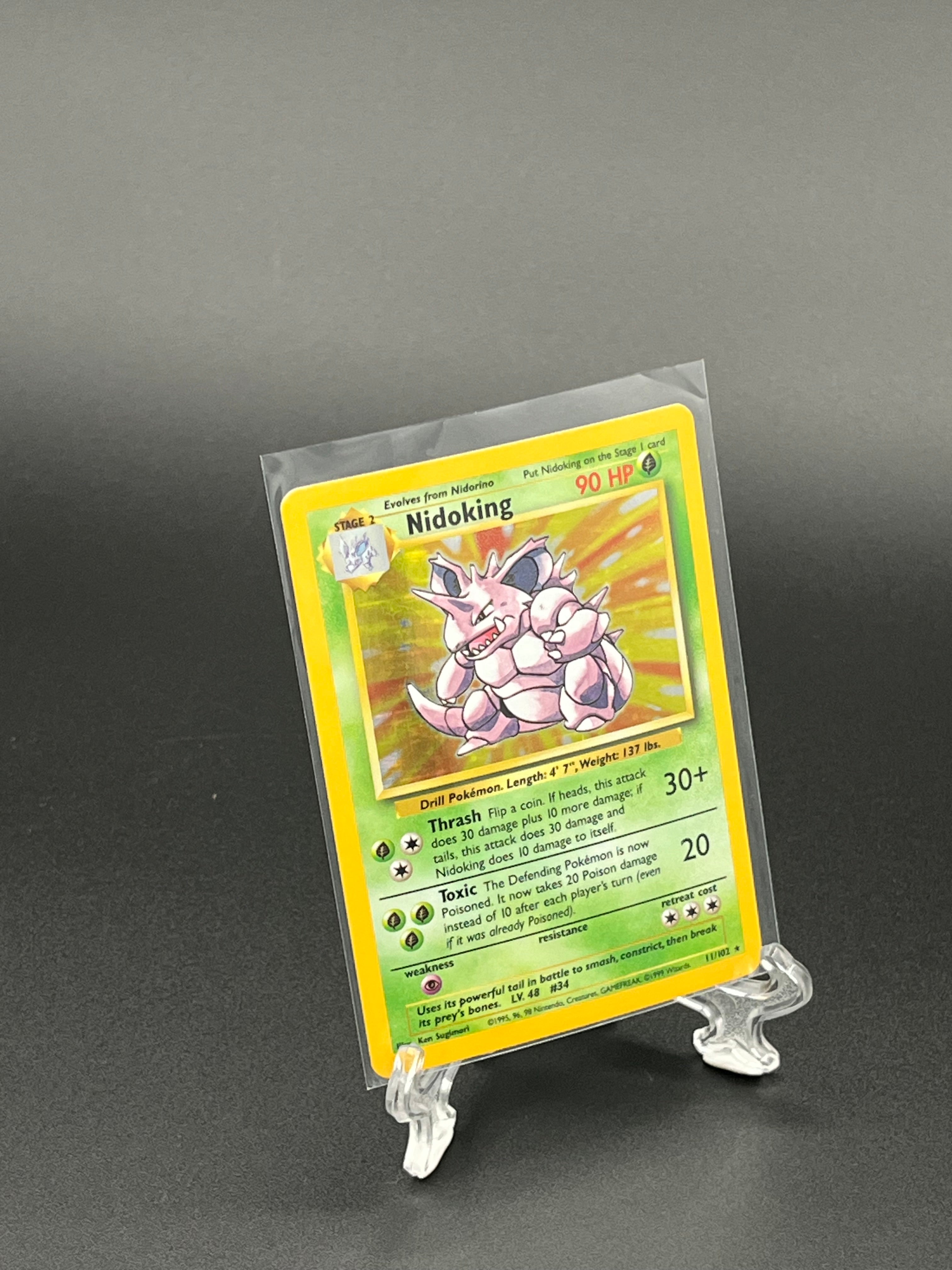 Pokémon trading card in a clear protective sleeve on a dark background