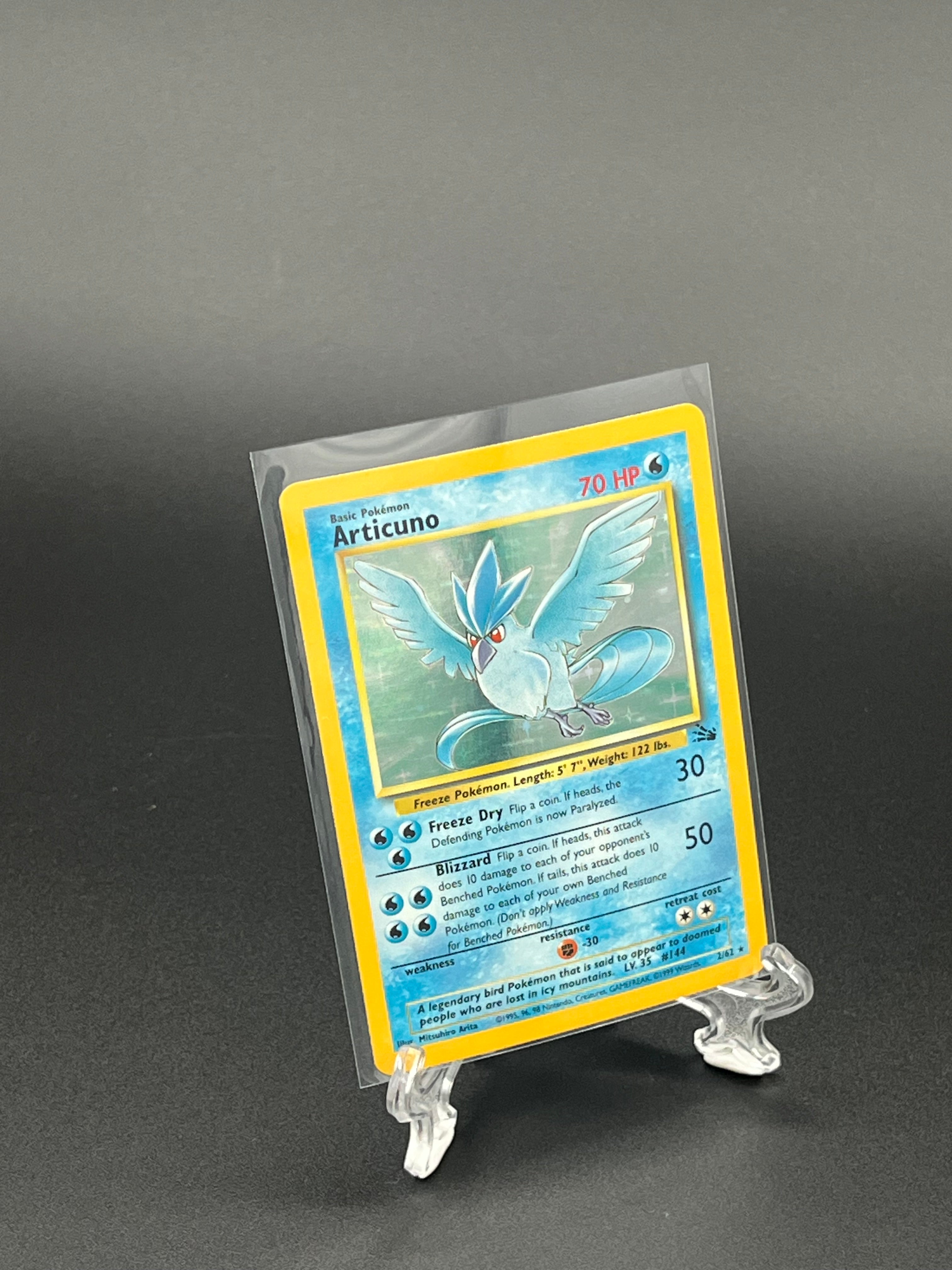 Trading card in a clear protective sleeve on a dark background