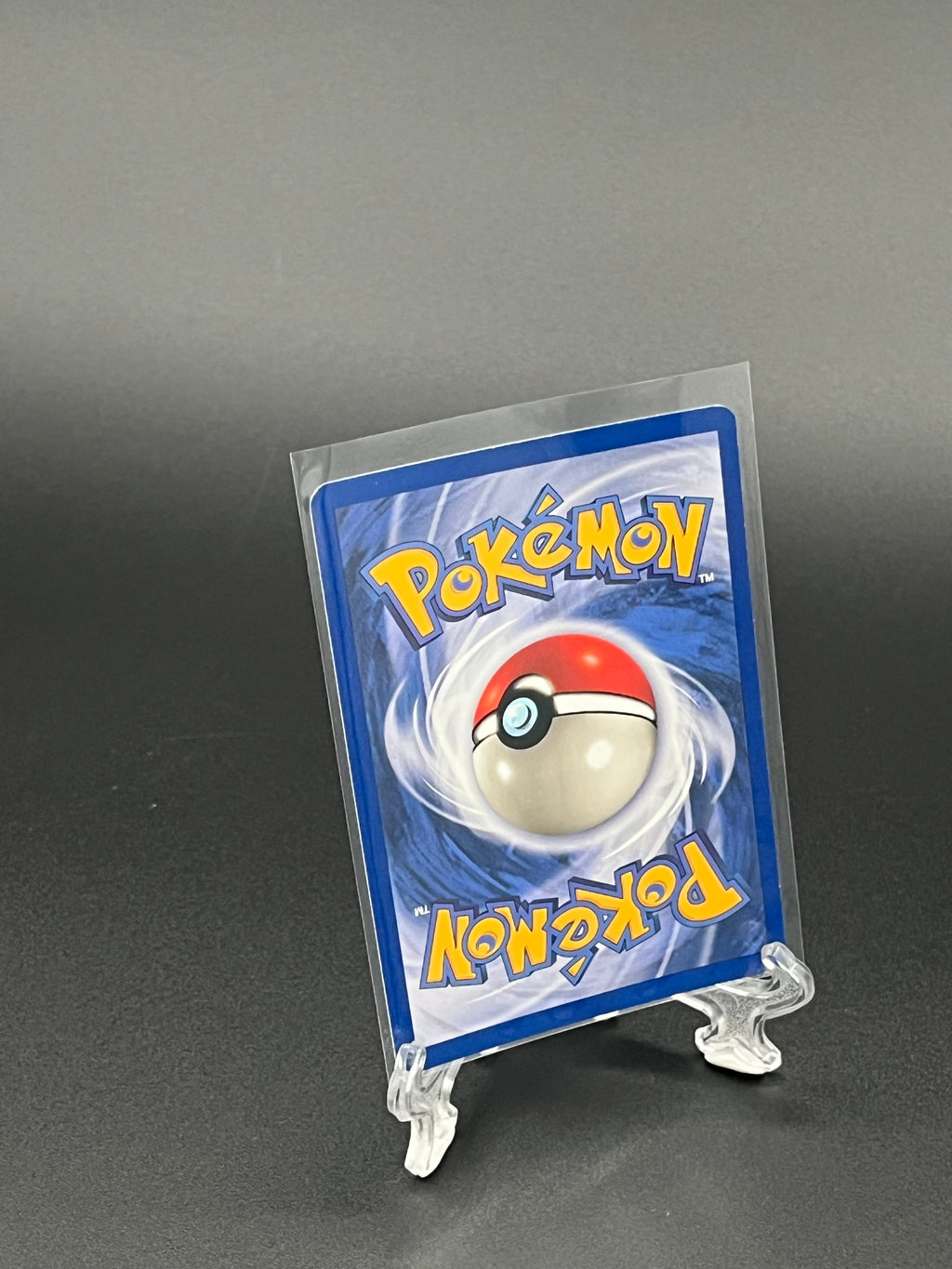 Pokémon trading card in clear packaging on a dark background