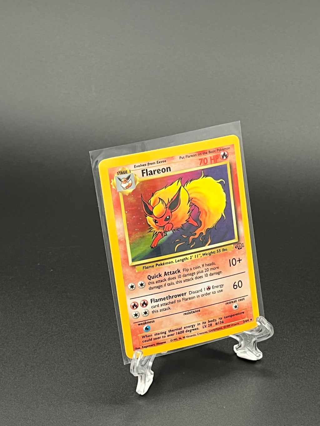 Pokémon trading card featuring Flareon in a clear protective sleeve on a dark background