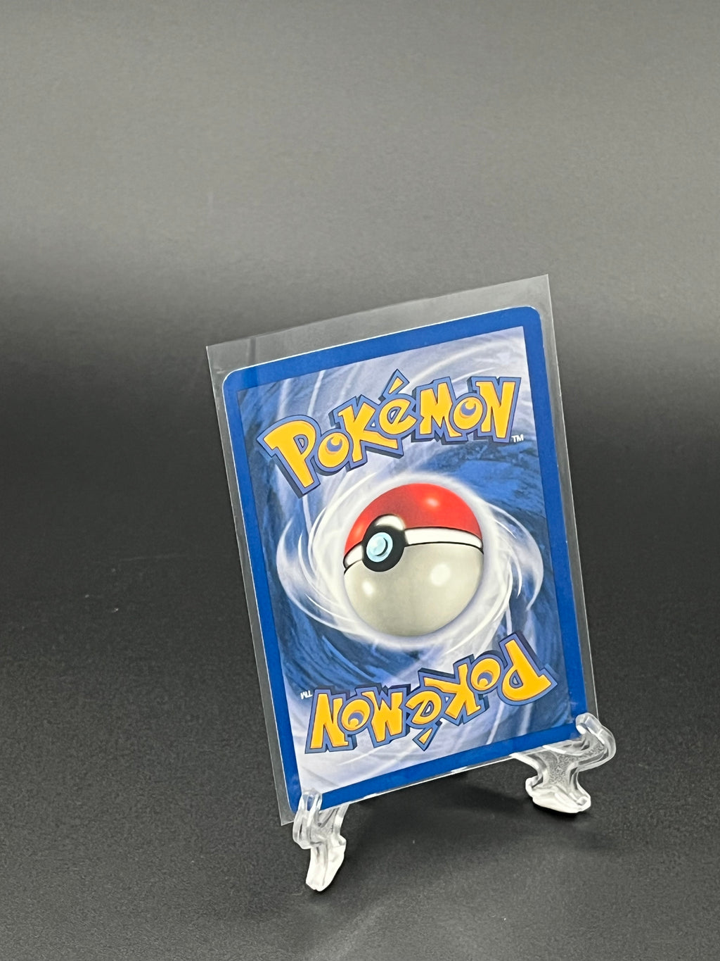 Pokémon trading card in protective sleeve on a dark background
