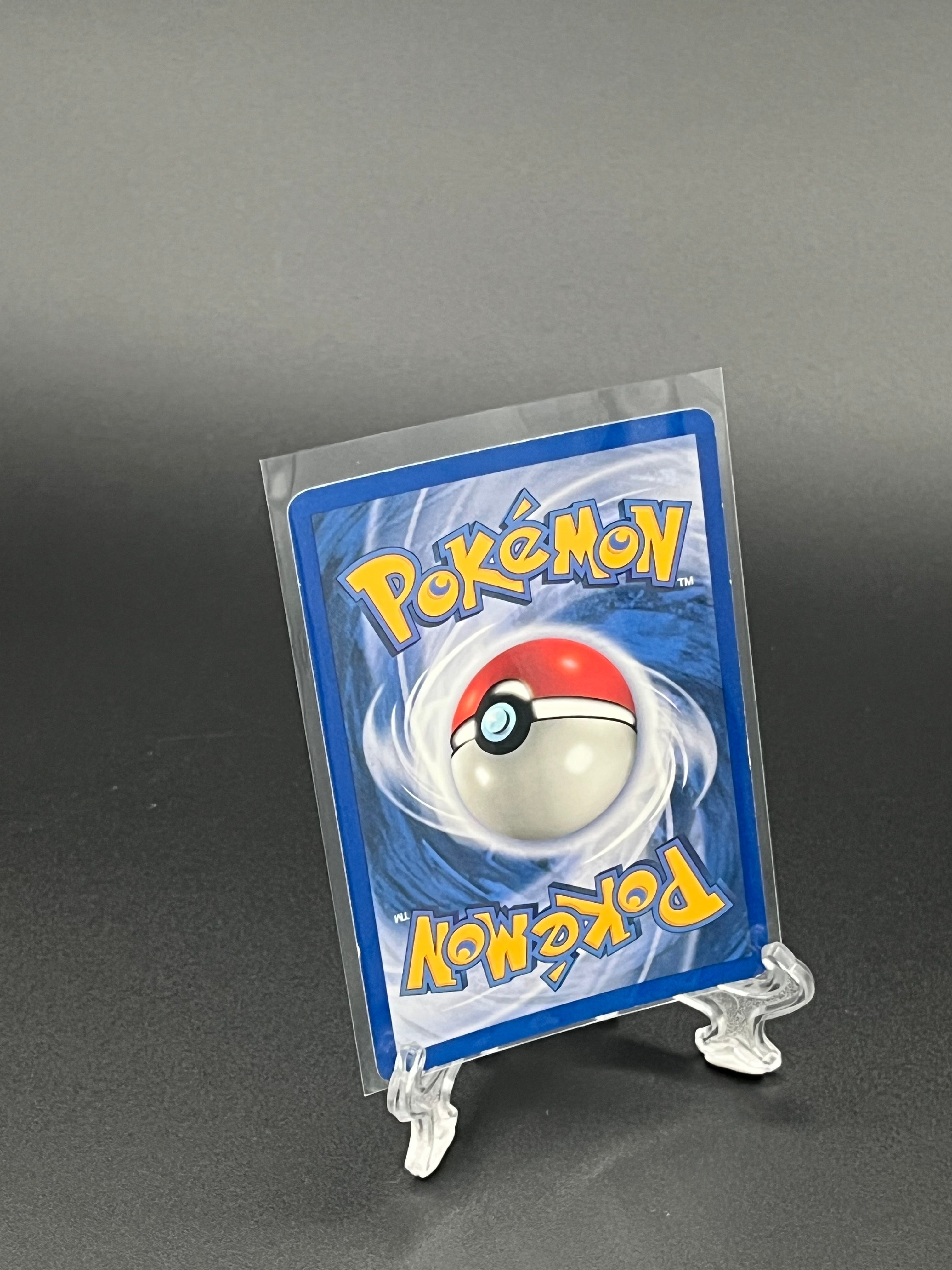 Pokémon trading card in clear packaging on a dark gray background