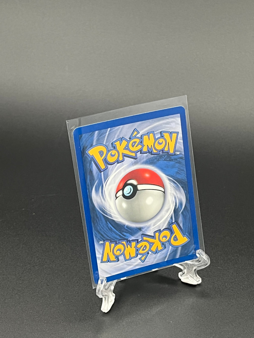Pokémon trading card in clear protective sleeve on a dark background
