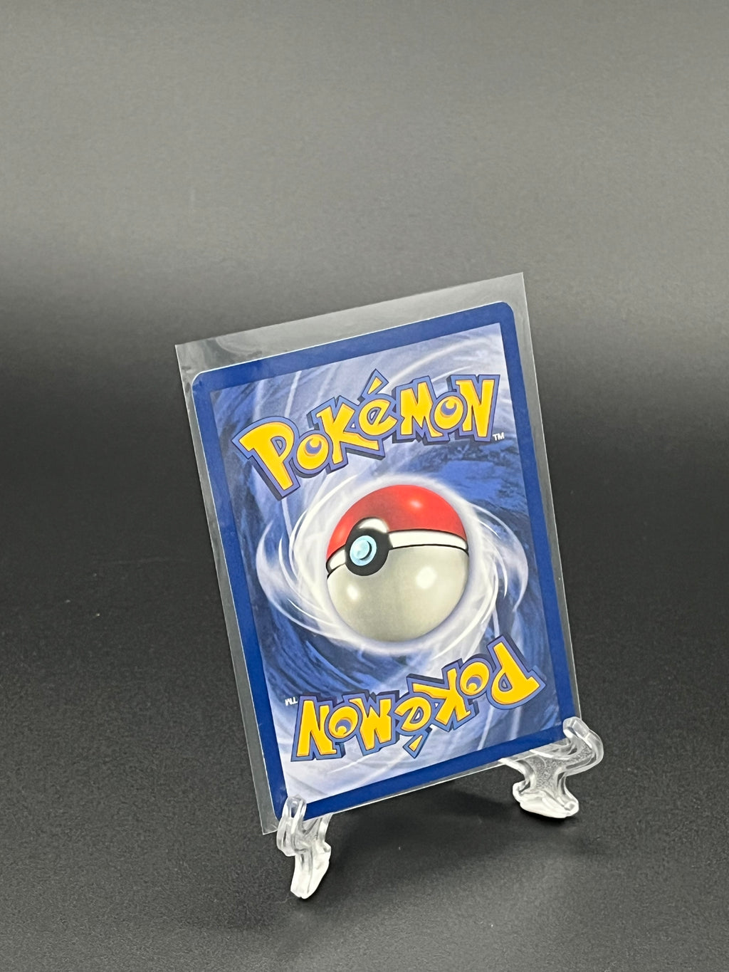 Pokémon trading card in clear packaging on a dark background