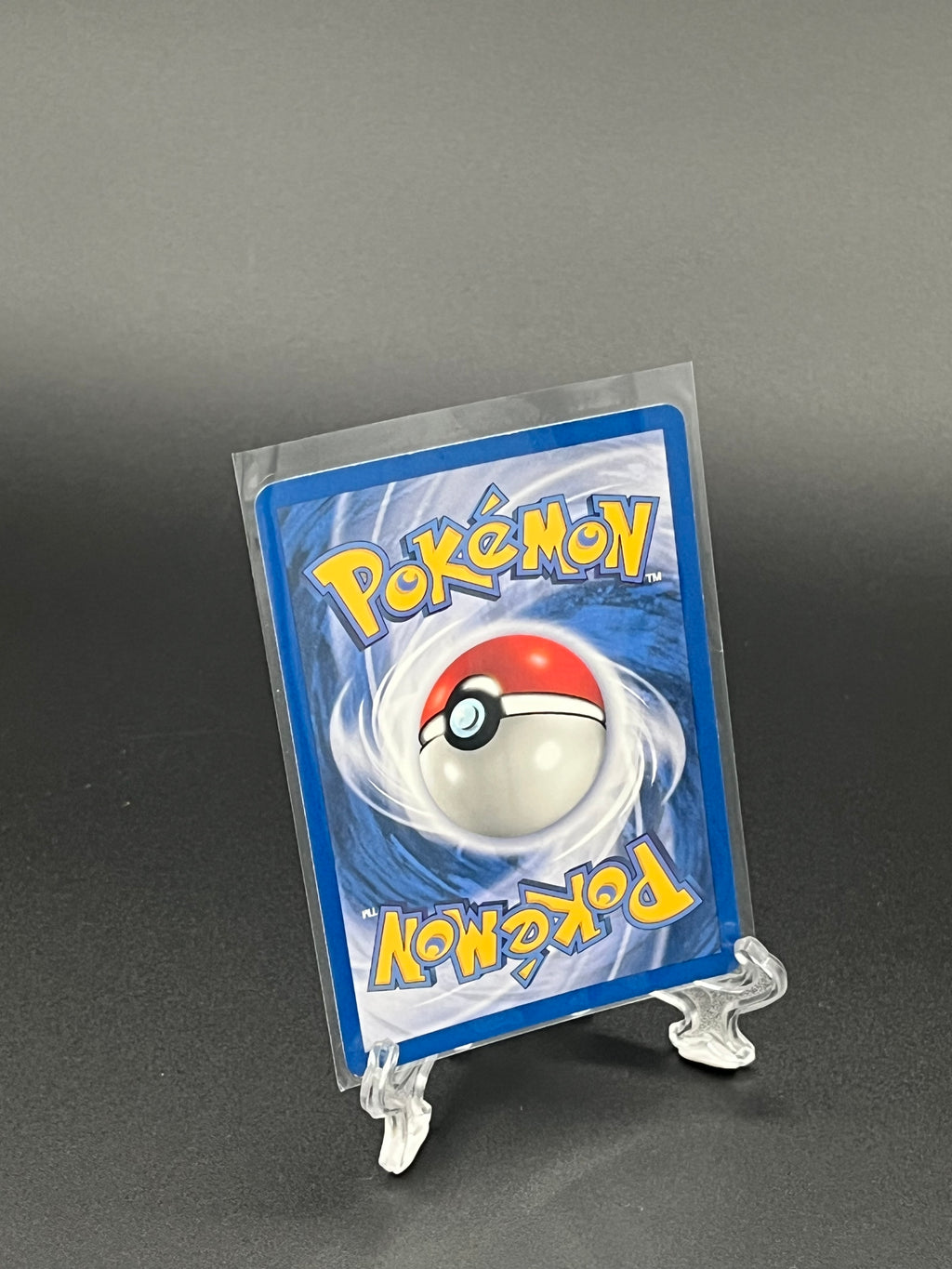 Pokémon trading card in clear packaging on a dark background