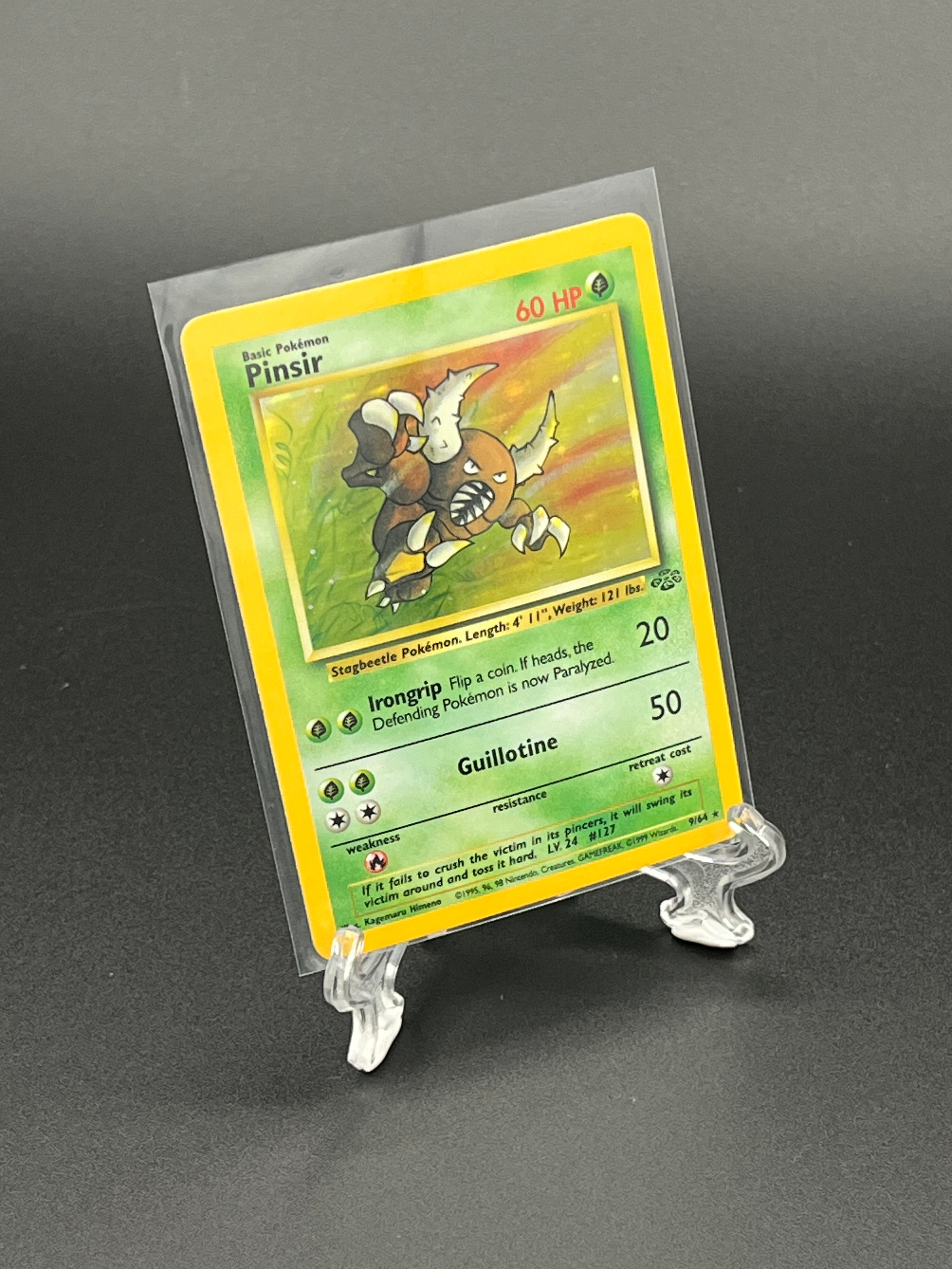 Trading card in a protective holder on a dark background