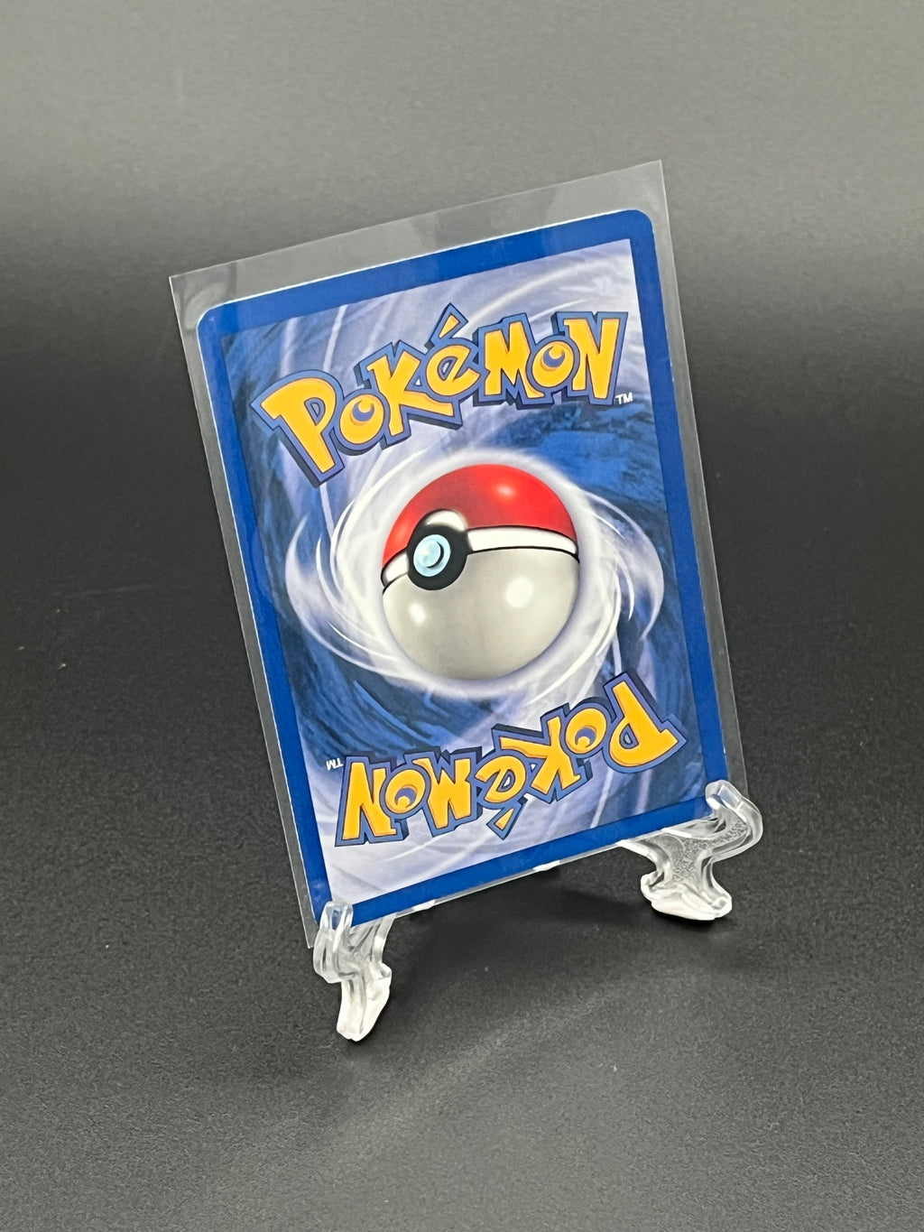 Pokémon trading card in protective holder on a gray background