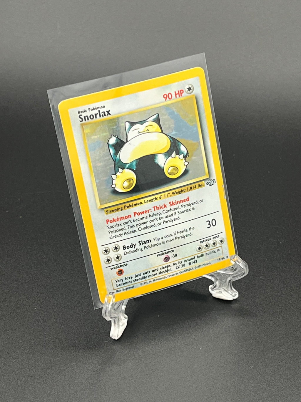 Pokémon trading card in a clear protective holder on a dark background