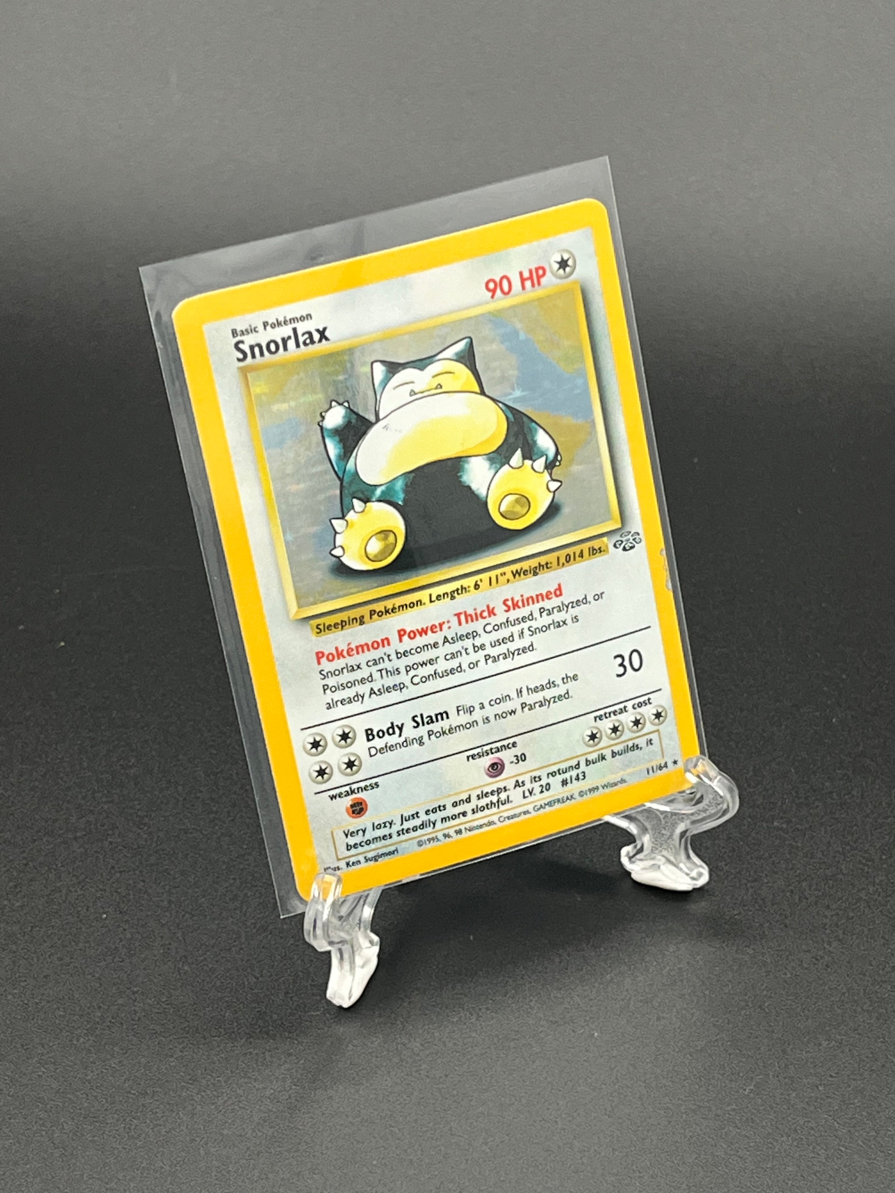 Pokémon trading card in a clear protective holder on a dark background