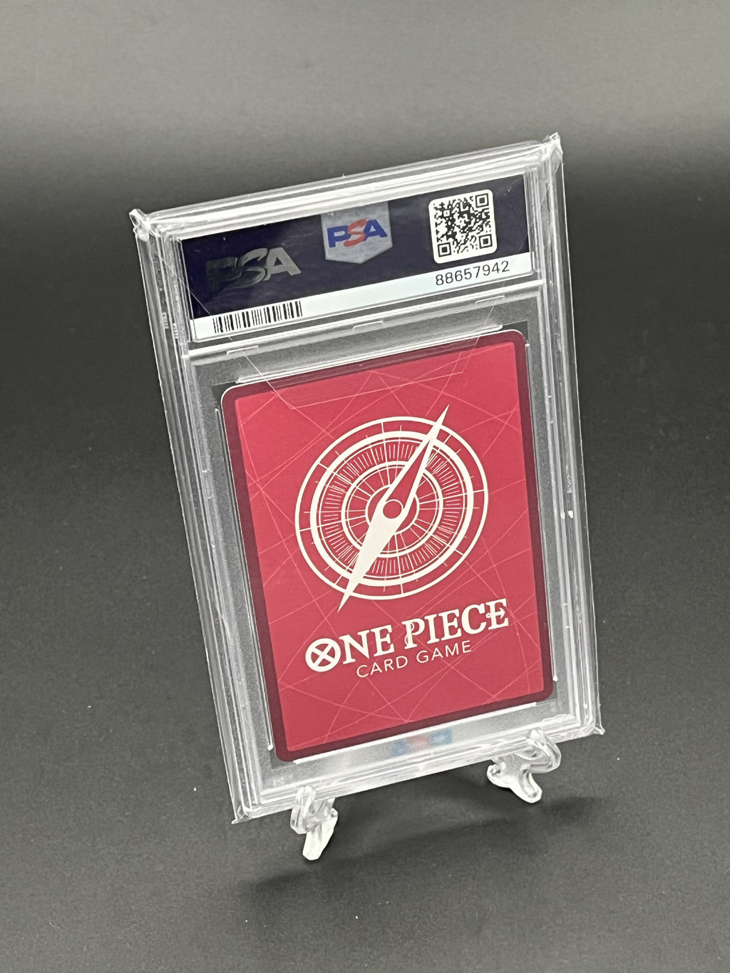 One Piece card game card in a protective case with a gray background