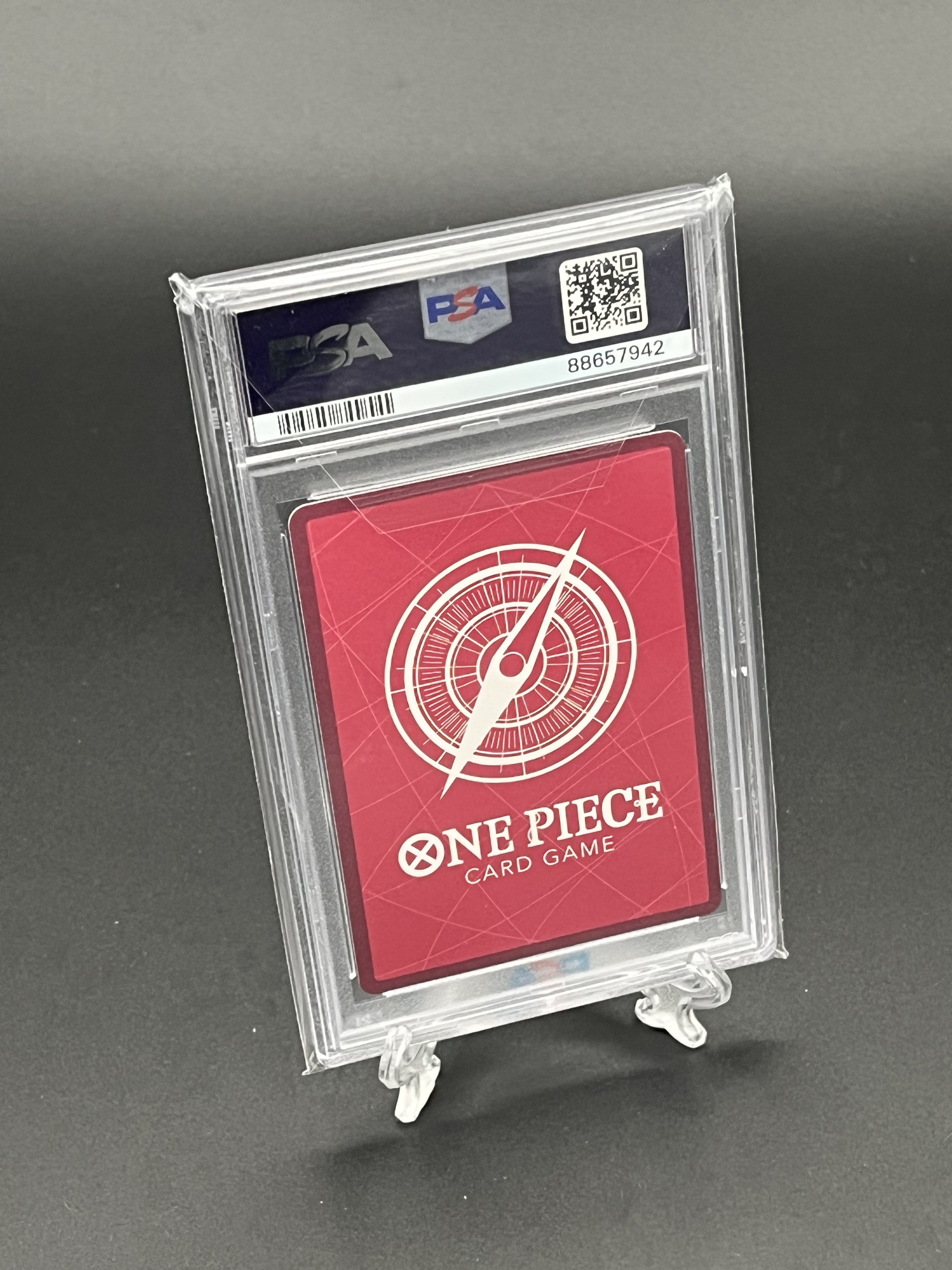 One Piece card game card in a protective case with a gray background