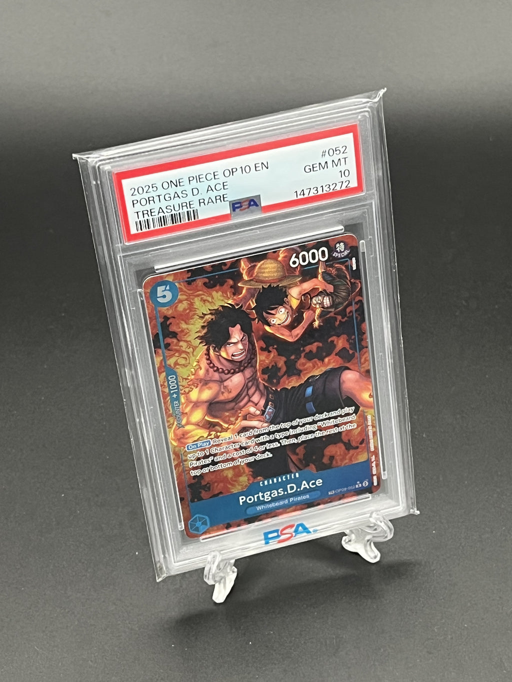Trading card featuring Portgas D. Ace from One Piece in a protective case on a gray background